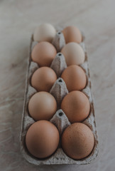 Organic farm eggs in an egg box. Chickens eggs from ecologically clean areas. Eggs of different colors. 