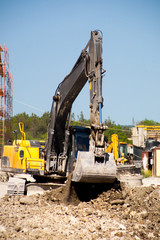 A large construction excavator of yellow color