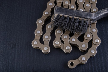 Bicycle chain and soft brush to clean dirt. Care of the bicycle's drive system.