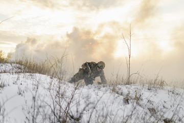 A Ukrainian soldier crawls from one position to another under fire. Russia attacked Ukraine
