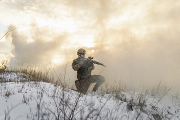 Soldier army man running through the smoke and explosions sun backlight and smoke background....