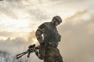 desperate American soldier breaks penetrat through the smoke to attack enemy. the atmosphere of a...
