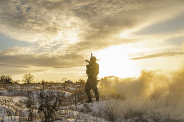 morning at dawn after a hard battle in the winter field or desert. exhausted army soldier Man....