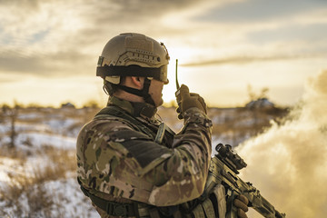 Ukraine war soldier army Man in multicam camouflage speaks on the walkie-talkie radio. equipment...
