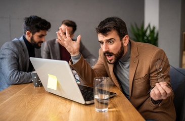 Three businessmen sitting in office