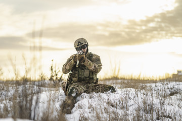 Modern war soldier army Man in the winter multicam camouflage is patrolling or patrol field...