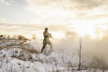 Soldier army man running through the smoke and explosions sun backlight and smoke background....