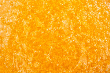 Transparent can of orange massage gel