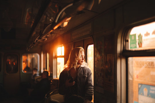Young woman looking through window traveling in subway train