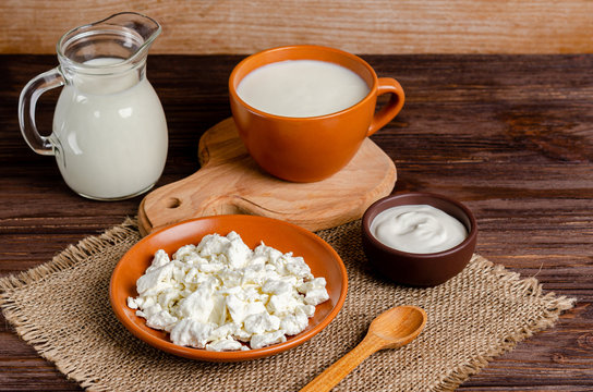 Homemade fermented milk products - kefir, cottage cheese on a wooden background