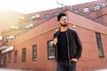 Handsome indian beard man in sunglasses outdoor at streets of city.