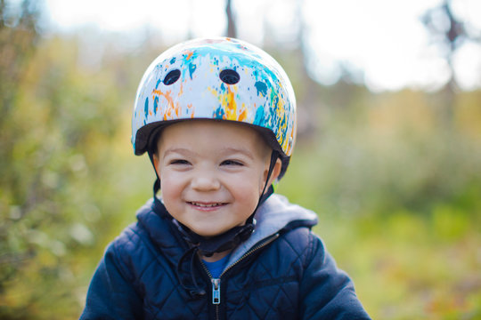 Portrait of young boy with bike helmet on.
