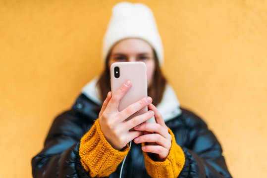 Young attractive woman taking picture of herself with a smartpho