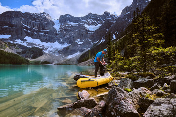 A man prepares for a rafting trip across Cirque Lake in Banff, Alberta