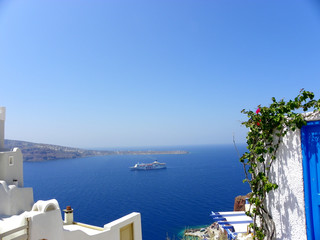 View on a blue sea and a ship from a Santorini island