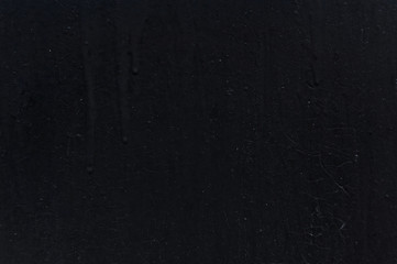 Black background wall painted many times with painted cracks and paint undercurrents