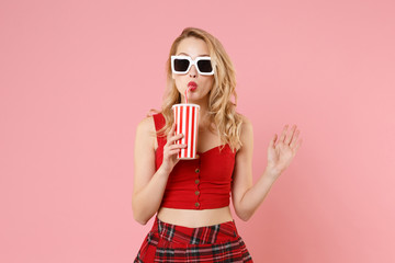 Beautiful young woman girl in red sexy clothes, dark sunglasses isolated on pastel pink wall background. People sincere emotion lifestyle concept. Mock up copy space. Hold plastic cup of cola or soda.