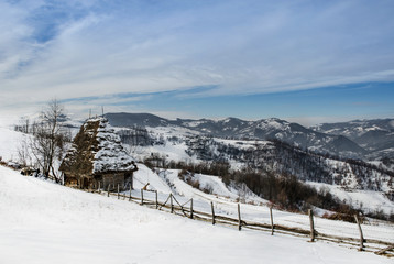 Fototapeta na wymiar Traditional houses in Dumesti village, Apuseni Mountains, Romania, in winter