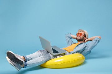 Traveler tourist man in yellow clothes, glasses isolated on blue background. Passenger traveling...