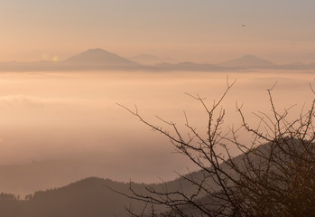 summit over a cloud sea in basque country, spain