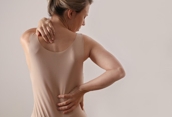 Woman with back and neck pain. Pure posture concept
