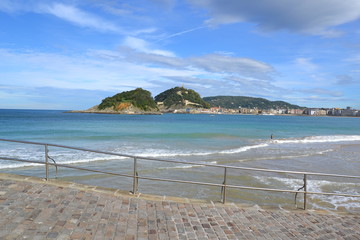 light blue and turquoise: fantastic sky over La Concha bay and Ondaretta beach in San Sebastian