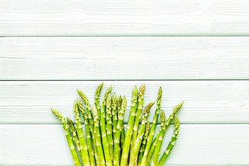 Fresh raw asparagus on white wooden background top-down copy space