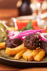 closeup of cevapcici with french fries