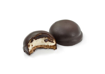 sweet marshmallow filled chocolate cream cakes and a cut one on a white background