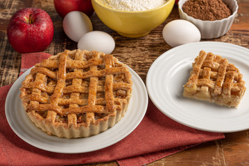 Homemade apple pie with cinnamon and a golden crust, on a wooden background