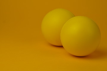 Yellow glossy game ball close-up on a yellow background.Yellow ball.