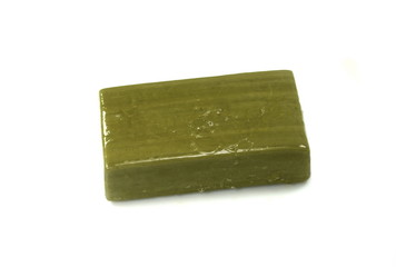Hand made Olive Soap bar with foam isolated on white background. Wet bar of soap.