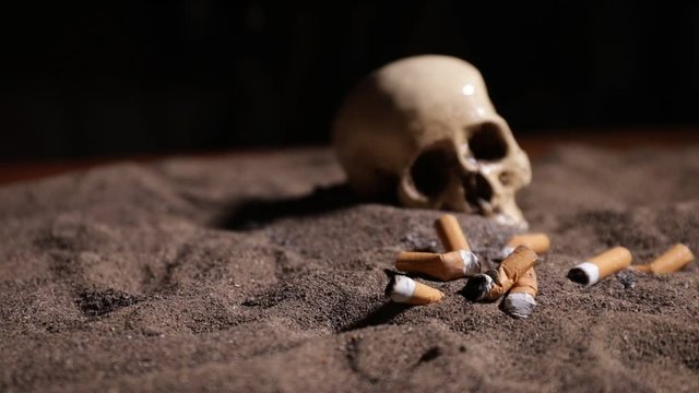 No smoking concept. Creative artwork table decoration with cigarettes. Cigarettes cause cancer and kill. still life skull and sigarette. Selective focus