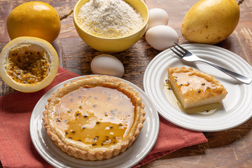 Homemade passion fruit pie with and a golden crust, on wooden background