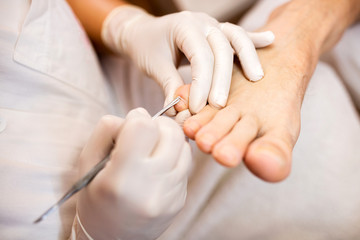 Close up foot nails cuticle treatment