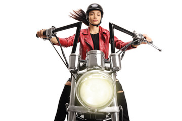 Portrait of a female biker riding a custom motorbike