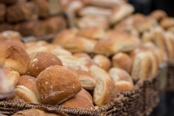 A pile of fresh bread made from white flour. Inside wicker baskets. Crispy, blurred background. The Market, Jerusalem.