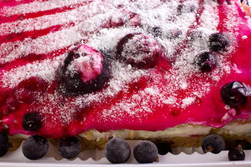 tasty sponge cake with wild berries and cream close-up