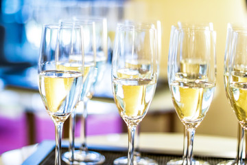 Glasses of champagne and sparkling wine served on a tray at charity event