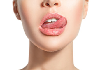 Woman's tongue seductively licking lips. Beautiful chubby lips. seduction concept.