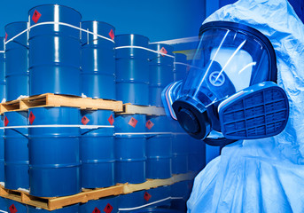Dangerous substances in tanks. Demonstration of a protective suit against the background of cans of...