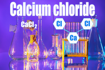 Chemical utensils and microscope on a blue background. Conducting research under a microscope. We...