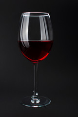 Elite red wine in beautiful glass on black background. Wine tasting and production concept, sommelier house. Luxury noblesse alcohol drink, bar and party. Alcohol addiction. Layout for design menu.