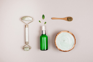 Modern cosmetics accessoires and ingredients on grey background. Flat lay style.