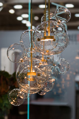 Lighting balls on the chandelier in the lamplight, light bulbs hanging from the ceiling.