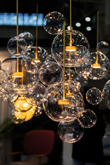 Lighting balls on the chandelier in the lamplight, light bulbs hanging from the ceiling.