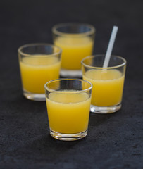 Orange juice in a glass on a dark background