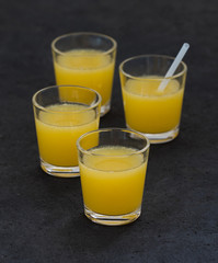 Orange juice in a glass on a dark background