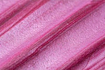 Texture of lip gloss. Smudged makeup product sample