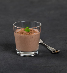 Italian dessert Panna cotta chocolate nut in a glass on a dark background